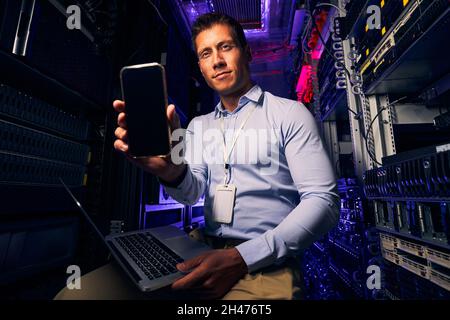 Caucasian IT technician working in server room Stock Photo