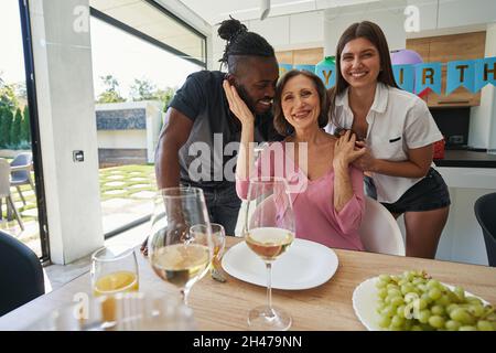 Female person is accepting congratulations from relatives Stock Photo