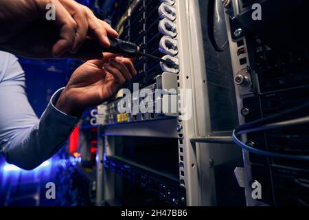 Engineer installing network equipment in data center Stock Photo