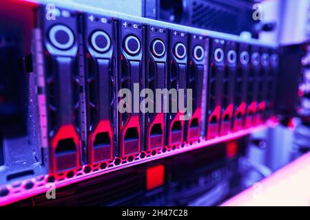 Up-to-date rack-mounted illuminated computer hardware in data center Stock Photo