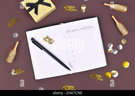 Writing new year’s resolutions, list on white notepad with ballpoint ...
