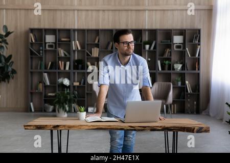 Pensive happy young businessman looking in distance. Stock Photo