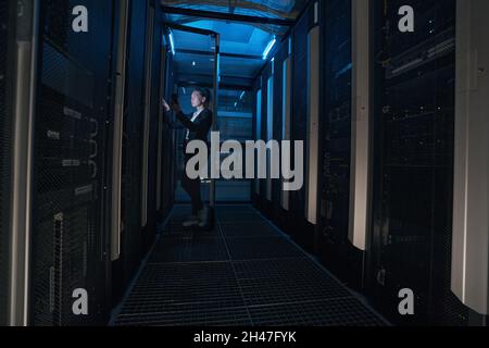 IT engineer checking servers in data center Stock Photo