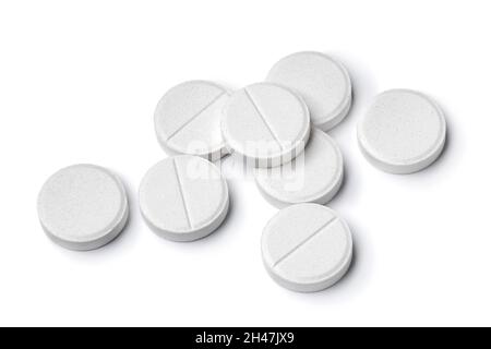 Heap of medical white tablets close up isolated on white background Stock Photo