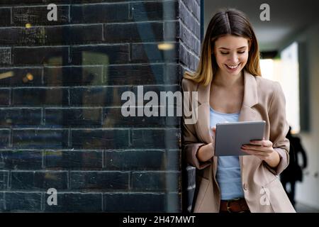 Portrait of successful woman using digital tablet in urban background. Business people concept Stock Photo