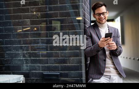 Portrait of successful business man, entrepreneur working in urban background Stock Photo