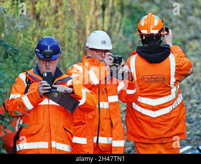 Officials from the Office of Road and Rail (ORR) and the Rail Accident Investigation Branch (RAIB) at the scene of a crash involving two trains near the Fisherton Tunnel between Andover and Salisbury in Wiltshire. Fifty firefighters were called to the scene of the collision on Sunday in which up to a dozen passengers are believed to have been injured. Picture date: Monday November 1, 2021. Stock Photo