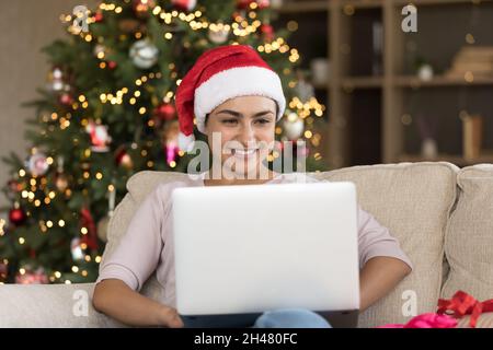 Happy beautiful young Indian woman using computer. Stock Photo
