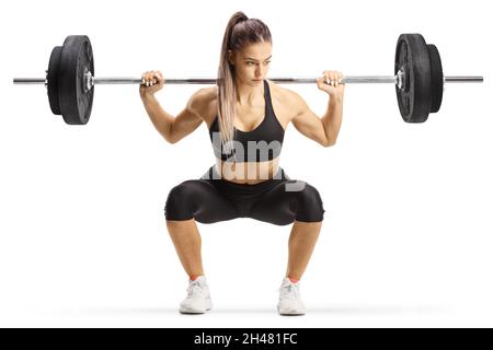 Fit young woman bodybuilder kneeling with heavy weights isolated on white background Stock Photo