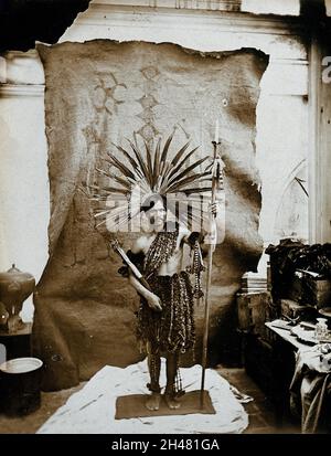 An Amazonian indigenous man wearing a feathered headdress and face ...
