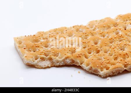 hard crispbread with crumbs and seeds on white background Stock Photo