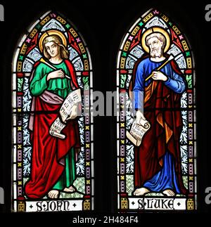 A stained glass window by Michael O'Connor depicting Saints Joan and Luke, St Michael & All Angels Church, Fringford, Oxfordshire Stock Photo