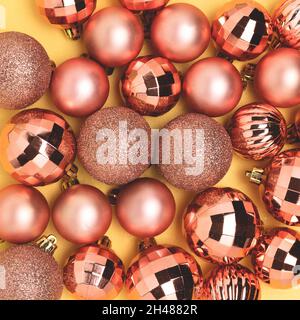 Rose gold colored Christmas toys. Festive texture concept. Stock Photo