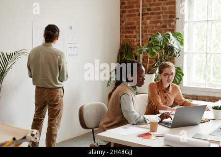 Diverse group of young creative architects working in modern office Stock Photo
