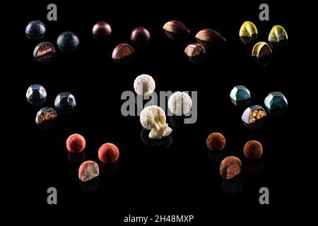 Collection of chocolates with filling. On a black background. Front view Stock Photo