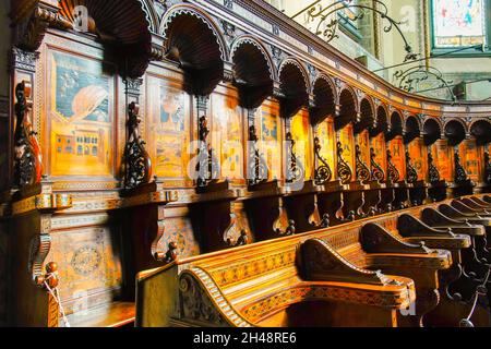 Choir stalls in Cathedral of San Lorenzo in Alba, Piedmonte Region, Italy. The cathedral is located in the eastern sector of the ancient city of Alba Stock Photo