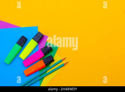 Stationery for drawing - top view of colored paper and multicolored markers. concept of education, training. Workplace with copy space close up Stock Photo