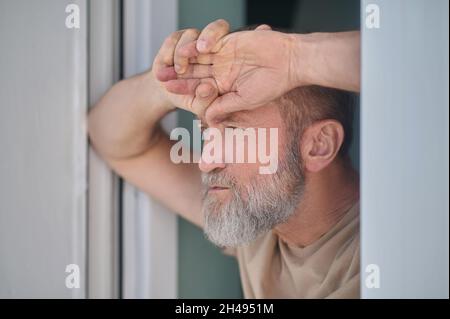 Serious pensive mature man looking at something Stock Photo