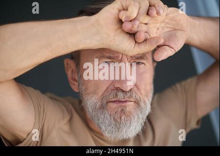 Attractive mature man pondering over a problem Stock Photo