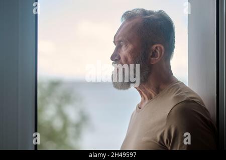 Thoughtful mature man looking into the distance Stock Photo