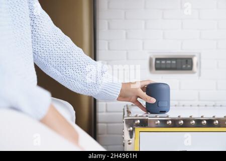 close-up on portable wireless speaker in hand on table, new technology speaker easy to use Stock Photo