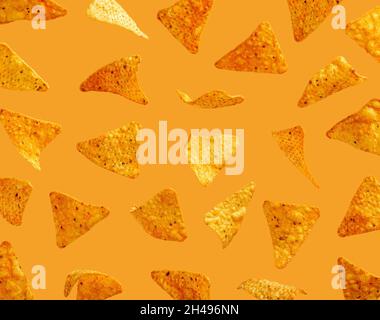 Nachos corn chips flying in the air on orange background Stock Photo