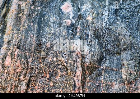 Natural stone background. Sea stone texture. Panel texture. Spots gray red background. Background fill. Stock Photo