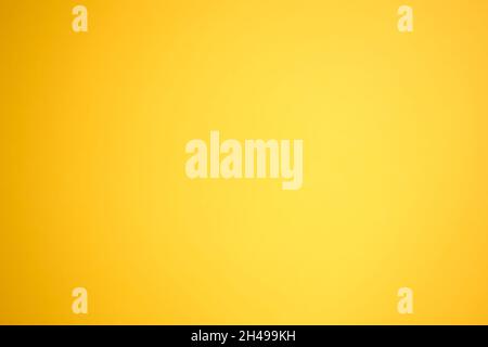 Orange background with a gradient to yellow. Orange paper top view. Abstract bright background without texture. Stock Photo