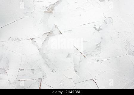 White putty background. White abstract texture of surface covered with putty. textured background of filler paste applied with putty knife in irregula Stock Photo