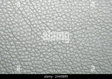 Grey leatherette texture background, faux leather pattern. Top view. Natural silver leather surface. Artificial eco leather closeup. Stock Photo