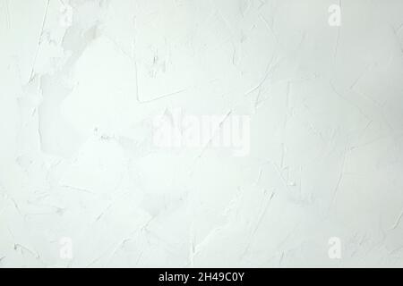 White putty background. White abstract texture of surface covered with putty. textured background of filler paste applied with putty knife in irregula Stock Photo