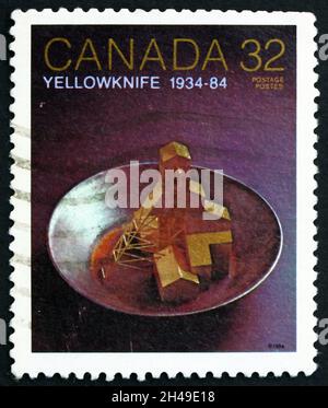 CANADA - CIRCA 1984: a stamp printed in Canada shows Yellowknife, gold mine, 50th anniversary, circa 1984 Stock Photo