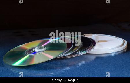 A stack of DVDs on a table with a reflection. Objects on a black background Stock Photo