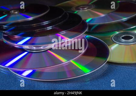A stack of DVDs on a table with a reflection. Objects on a black background Stock Photo
