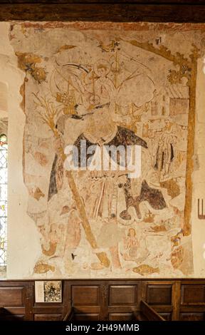 Historic wall paintings inside St James' Church, Bramley village, Hampshire, UK, a Grade I listed building. 16th century painting of St Christopher. Stock Photo