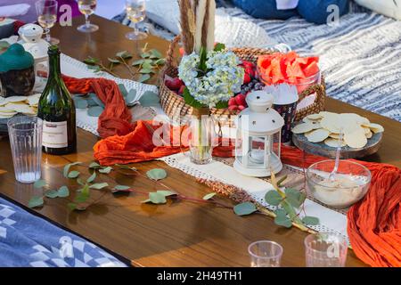 picnic in park babyshower with wine and lantern Stock Photo