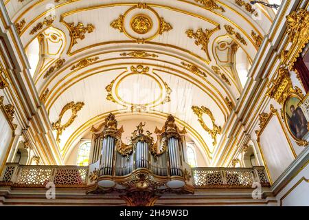 Pipe organ and ceiling part of the interior architecture of the Church of Nossa Senhora do Monte do Carmo da Antiga Sé in Rio de Janeiro, Brazil. The Stock Photo