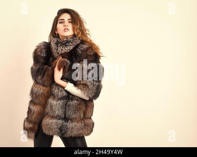 Fur store model enjoy warm in soft fluffy coat with collar. Fur fashion concept. Winter elite luxury clothes. Woman makeup and hairstyle posing mink Stock Photo