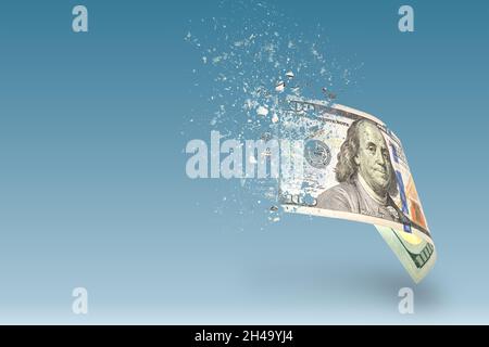 Inflation, hyperinflation, dollar stagflation. One hundred dollar bill sprayed on a blue background. The bill casts a shadow. The concept of declining Stock Photo