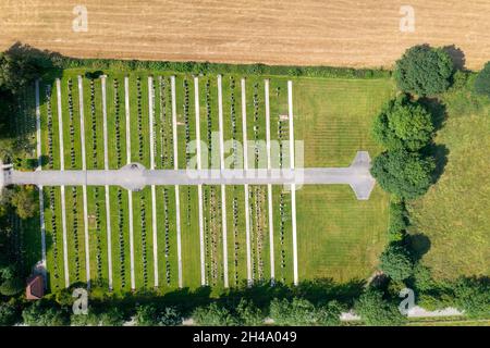 Straight down aerial drone photo of the town of Huntington in York in the UK showing a grave yard with rows of grave stones along side a farmers field Stock Photo