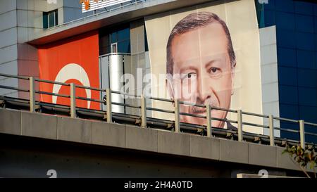 An exterior view of AK Party Izmir Provincial Directorate; The big poster of Turkey's president Recep Tayyip Erdogan, The Turkish flag  are hanged on the exterior of the building on October 30, 2021 in Bayraklı, Izmir, Turkey. Stock Photo