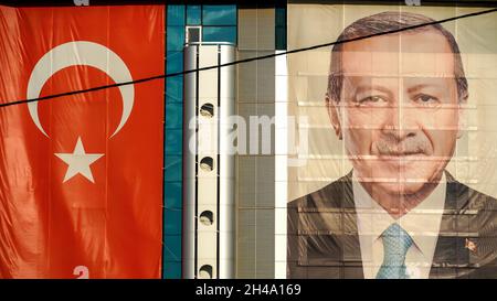 An exterior view of AK Party Izmir Provincial Directorate; The big poster of Turkey's president Recep Tayyip Erdogan, The Turkish flag  are hanged on the exterior of the building on October 30, 2021 in Bayraklı, Izmir, Turkey. Stock Photo