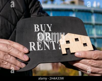 Buy or rent property question on the plate. Stock Photo