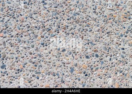 Background of multi-colored pebbles on the seashore. Sea stones of various sizes cover the sea coast. Pebble texture. Concept of natural background fr Stock Photo