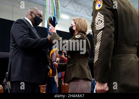 Doral, United States of America. 29 October, 2021. U.S. Secretary of Defense Lloyd Austin passes the Southern Command guidon to the incoming commander Army Gen. Laura J. Richardson during the change of command ceremony, October 29, 2021 in Doral, Florida. Credit: Lisa Ferdinando/DOD/Alamy Live News Stock Photo