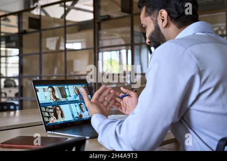 Indian smiling executive ceo businessman having working video call in office. Stock Photo
