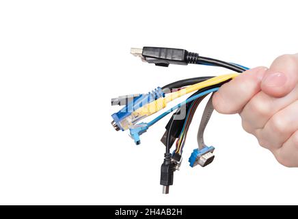 Bunch of computer cables in women's hand isolated on white background. Bundle of computer interface cables with different connectors Stock Photo