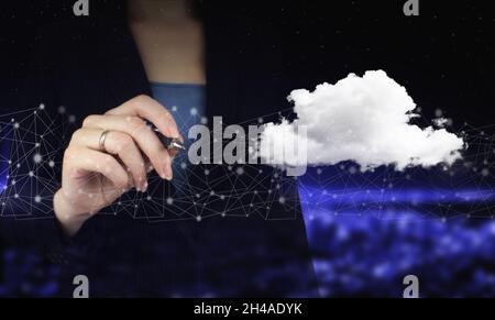 Cloud computing technology internet concept background. Hand holding digital graphic pen and drawing digital hologram cloud sign on city dark blurred Stock Photo