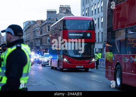 Glasgow, Scotland, UK. 1st Nov, 2021. COP26 - temporary ring of steel around Kelvingrove Museum and massive police presence in the surrounding areas of the West End of Glasgow ahead of a COP26 evening reception. Pictured - red electric London double decker buses drive along the road through Finnieston which has been completely sealed off by police to create a safe route for world leaders arriving at Kelvingrove Museum from the SEC campus. Credit: Kay Roxby/Alamy Live News Stock Photo