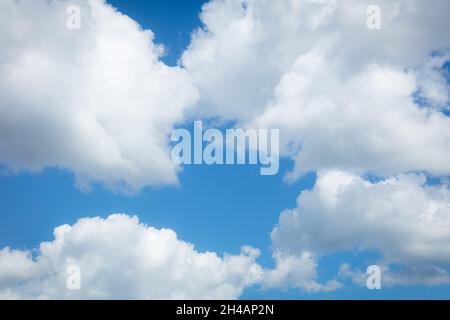 Puffy white clouds against a blue sky Stock Photo